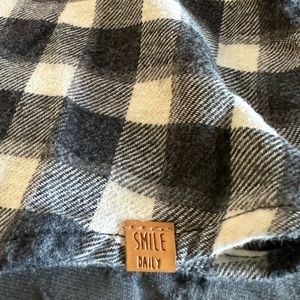 Young child’s light flannel shirt with front pocket and simple collar.